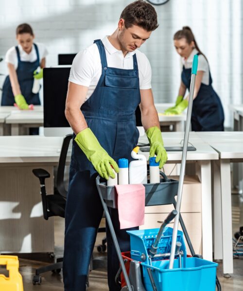 young-cleaner-standing-near-cart-with-cleaning-supplies.jpg young-cleaner-standing-near-cart-with-cleaning-supplies.jpg