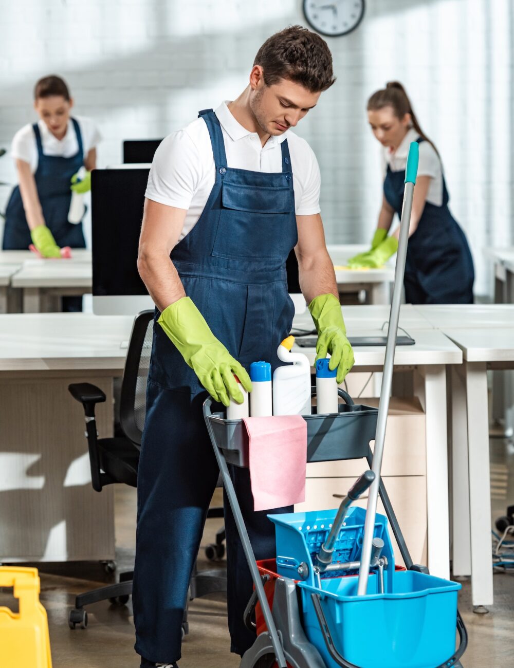 young-cleaner-standing-near-cart-with-cleaning-supplies.jpg young-cleaner-standing-near-cart-with-cleaning-supplies.jpg